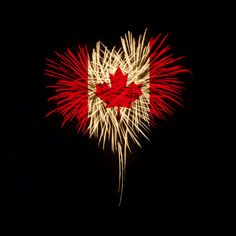 the canadian flag is lit up with fireworks