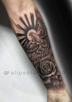 an eagle and rose tattoo on the arm