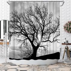 a black and white shower curtain with a tree in the snow on it's side