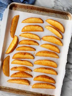 sliced apples on a baking sheet ready to be baked in the oven for roasting