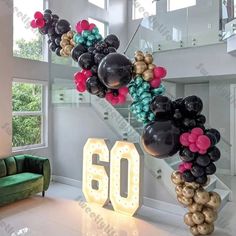 a staircase made out of balloons with the number 60 on it in front of a green couch