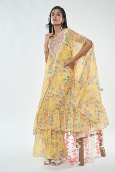 Yellow kaftan style flared cape with floral prints, cutdana, thread work embroidered yoke and frilled hem. Comes with coordinating sharara and solid blouse. - Aza Fashions Yellow Floral Print Kurta For Wedding, Yellow Palazzo Set With Printed Motifs For Wedding, Wedding Yellow Palazzo Set With Printed Motifs, Yellow Georgette Sets With Printed Motifs, Yellow Printed Motifs Sets For Wedding, Yellow Printed Motif Sets For Wedding, Yellow Printed Sets For Wedding, Yellow Sets With Printed Motifs For Wedding, Yellow Wedding Sets With Printed Motifs