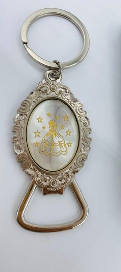 a keychain with an image of a baby in the center and stars on it