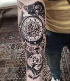 a man with a tattoo on his arm has a clock and roses in the background