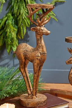 two wooden deer figurines sitting on top of a table