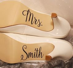 two pairs of white shoes with mr and mrs written on them