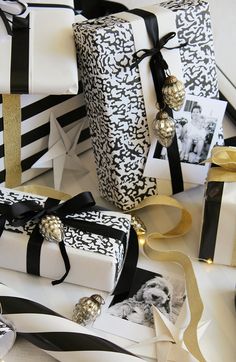 presents wrapped in black and white paper with gold accents