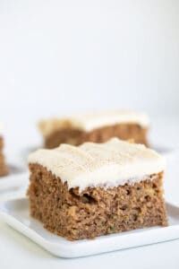 two pieces of cake sitting on top of a white plate next to another piece of cake