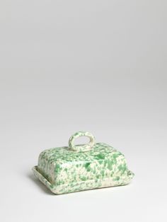 a green and white box sitting on top of a table