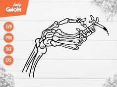 a skeleton hand holding a knife on top of a white wooden table with snowflakes around