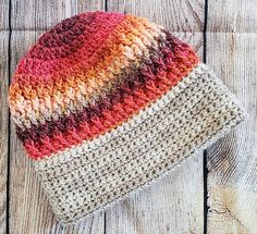 a crocheted hat sitting on top of a wooden table