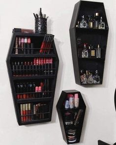 two black shelves with lipstick and cosmetics on them