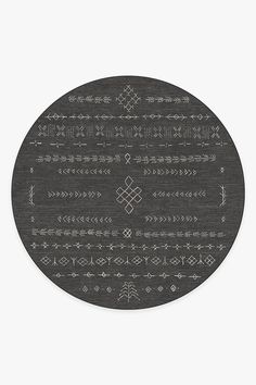 a black and white round rug with an intricate design