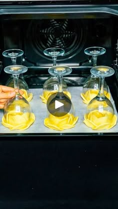 an oven filled with yellow liquid and wine glasses