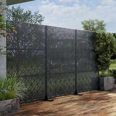 an outdoor area with wooden flooring and a large metal fence on the side of it