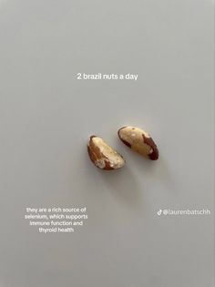 there are two nuts on the table and one is half eaten