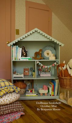 a dollhouse book shelf with toys and books