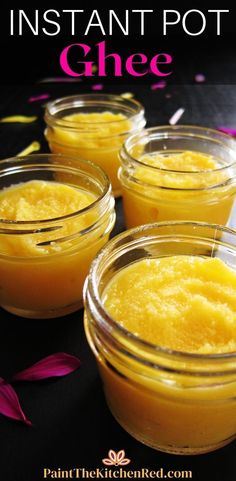 three small jars filled with yellow gel sitting on top of a black table next to purple flowers