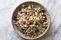 a bowl filled with rice and nuts on top of a table