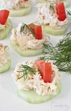 cucumber and tomato appetizers with dill on them