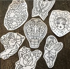 paper cut outs with images of angels and flowers on them, sitting on a table