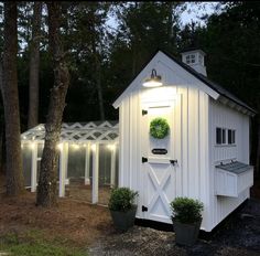 a small white shed with lights on it