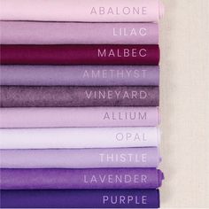 purple and white sheets are stacked on top of each other, with the words above them