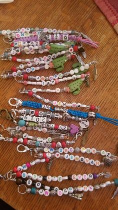 a table topped with lots of different types of key chains and bracelets on top of each other