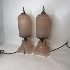 two brown glass lamps sitting next to each other