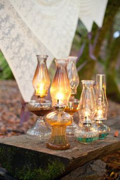 an assortment of glass vases sitting on top of a rock