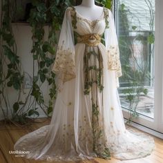 a dress on display in front of a window with ivy growing up the wall behind it