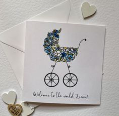 New baby card for a boy with the words ' 'Welcome to the world ( baby's name).' accompanied by a watercolour and ink illustration of a vintage style pram made up of flowers, some centred with pink gem stones for a touch of sparkle.  The card is blank inside for your own message. The card is crisp white 300gsm card  sold with a quality white envelope. It is 13.5 cm squared when closed. Each card will be packed in a hard backed envelope via first class post with Royal Mail. Christian Birthday Cards, Nativity Christmas Cards, Welcome Baby Cards, Baby Congratulations Card, Vintage Pram, Christian Birthday, Paintings Tutorials, Baby Boy Cards, New Baby Card