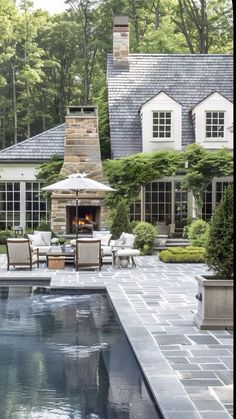 an outdoor fireplace in the middle of a pool