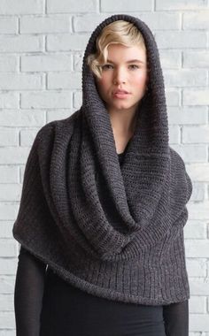 a woman wearing a gray knitted shawl