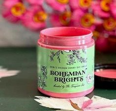 a jar of bougman brights next to a flower