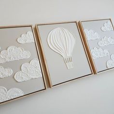 three white cards with hot air balloons cut out of paper in the shape of clouds