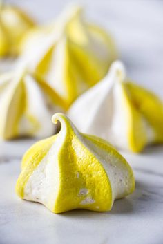 some yellow and white desserts on a table