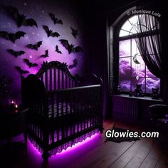 a crib with bats on the wall and purple lights in the room above it