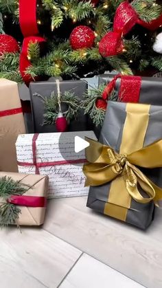 several wrapped presents sitting next to a christmas tree