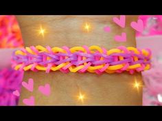 a woman's arm with pink, yellow and purple bracelets on top of it