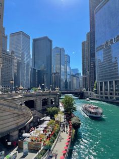 a boat traveling down a river next to tall buildings