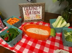 a table topped with containers filled with different types of vegetables next to a sign that says grazing station