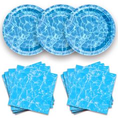 blue plates and napkins in the shape of a swimming pool with water ripples