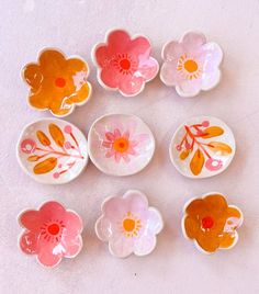 six flower shaped dishes sitting on top of a table