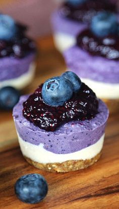 small blueberry cheesecakes are arranged on a cutting board