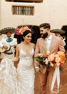 a bride and groom walking down the street