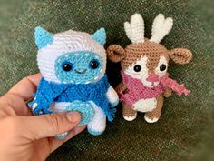 two small crocheted animals sitting next to each other