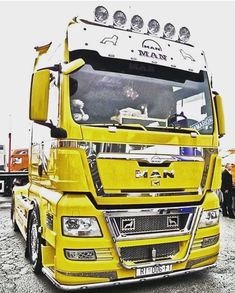 a large yellow truck parked in a parking lot