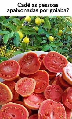 a bowl filled with sliced tomatoes on top of a table