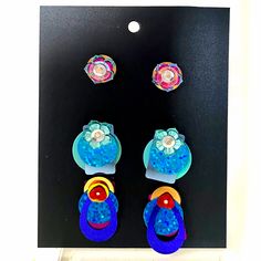 Looking for a fun and fashionable way to add some personality and sparkle to any outfit? Look no further than these fidget-friendly earrings! With so many fun styles to choose from, each pairing has its own unique flair. The designs are created from layers of sequins that move freely from a center point stud, creating a mesmerizing effect that's sure to turn heads. These earrings are perfect for situations where you wouldn't want to risk losing more valuable items. And with their affordable price point, they're a great way for parents to let their little ones add some style without breaking the bank. Whether you're going out dancing or just running errands, these earrings will steal the spotlight and have you feeling carefree as they flash sparkles in all directions. Be noticed wherever yo Trendy Multicolor Dangle Plug Earrings, Trendy Multicolor Drop Plug Earrings, Fun Blue Drop Earrings, Multicolor Flower Drop Earrings For Party, Trendy Multicolor Flower Earrings For Party, Trendy Colorful Earrings, Trendy Rainbow Earrings For Party, Colorful Funky Earrings For Party, Funky Drop Earrings For Party